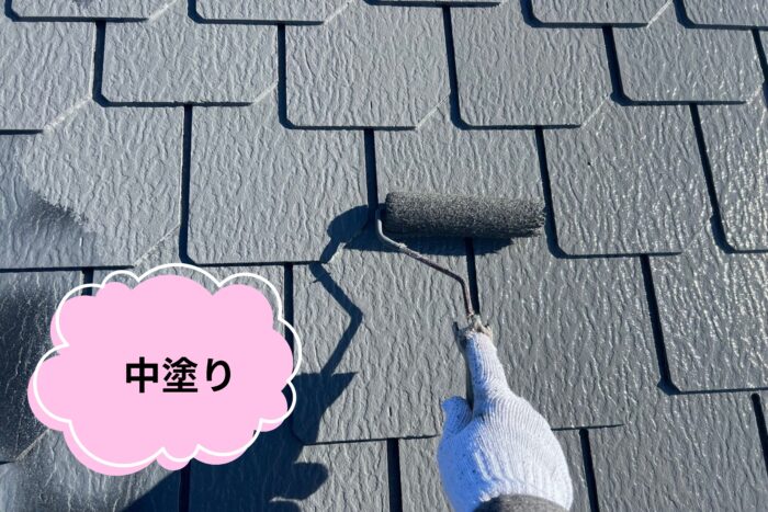 中塗りとしてグレーの塗料を均一に屋根へ塗布している写真