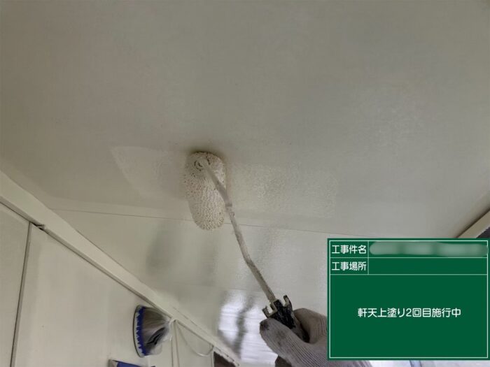 春日井市石尾台の住宅で軒天の上塗り2回目を施工している様子